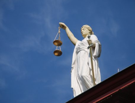 Picture of Justice with scales on top of building for reforms to fast track proceedings for litigation