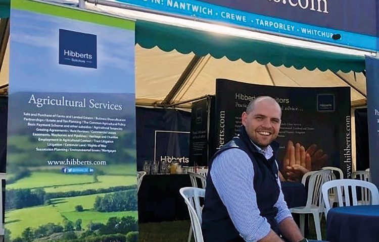 Oliver Lewis, white man sitting outsude the Hibberts Marquee at the Natwich Show